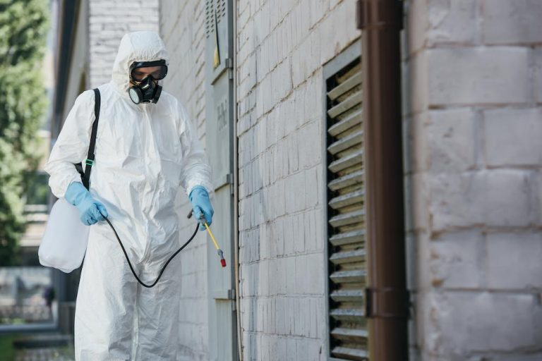 Work with The Fumigation Company for Industrial Fumigation expertise image shows individual fumigating exterior of building