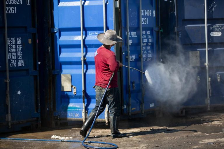 Protect your products with Export Fumigation services from The Fumigation Company image shows worker next to cargo container